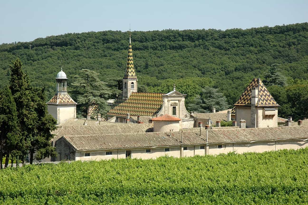 Luftaufnahme der Chartreuse de Valbonne im Département Gard mit Blick auf die farbigen Dächer der Klostergebäude.